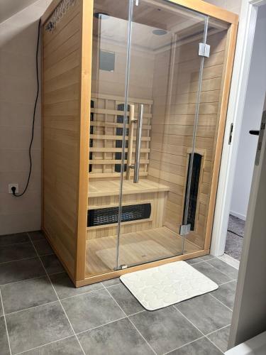 a shower with a glass door in a room at Apartman Bojnice Kúpele in Bojnice