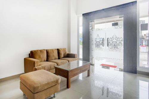 a living room with a couch and a chair and a table at Dancenter Griya Bawean in Tanjungkarang