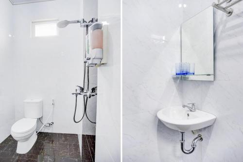 a white bathroom with a toilet and a sink at Dancenter Griya Bawean in Tanjungkarang