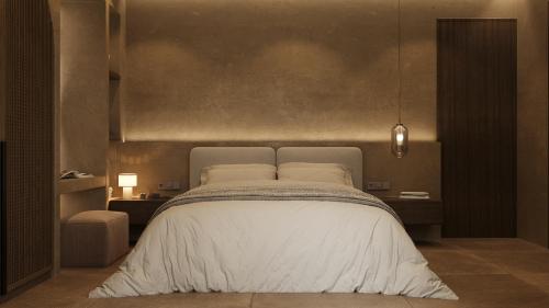 a bedroom with a large bed with white sheets at 12 Islands Villas in Kolimbia