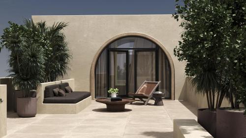 a patio with a couch and a chair and trees at 12 Islands Villas in Kolimbia