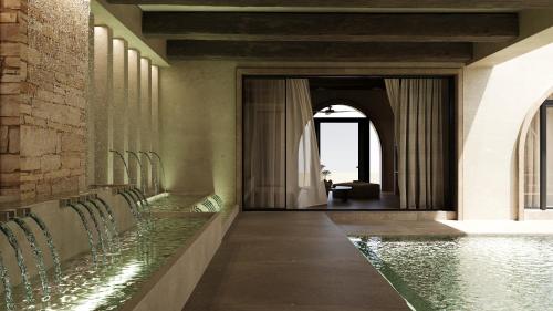 a hallway with chairs and a pool of water at 12 Islands Villas in Kolimbia