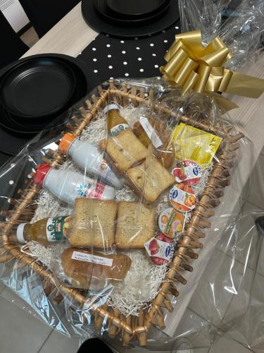 a basket filled with food and drinks on a table at Airb&b Family Milano-Cortina in Milan
