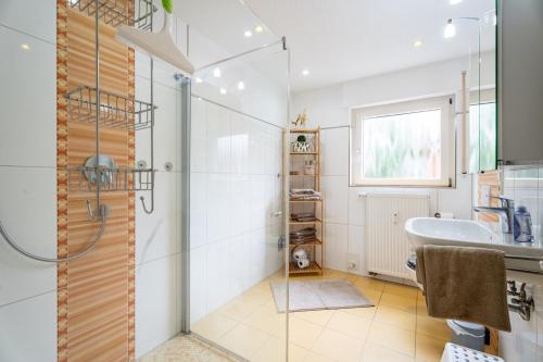 a bathroom with a shower and a sink and a tub at Ferienwohnung Kinzigtalblick in Wolfach