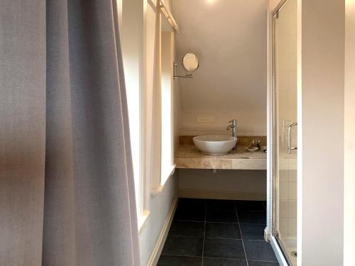 a bathroom with a sink and a mirror and a window at 4 Bed in Goathland G0042 in Goathland