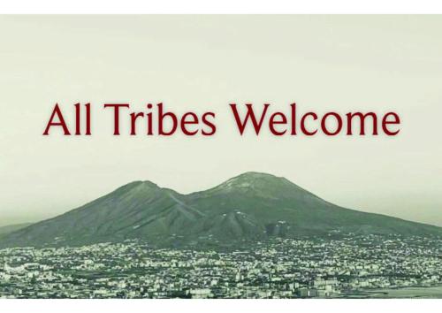 a sign that reads all titles welcome with a mountain at Voglia 'e turnà in Naples