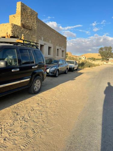 a shadow of a car parked on the side of a road at Tanirt ecolodge in Siwa
