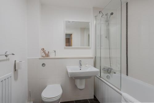 a bathroom with a toilet and a sink and a shower at City Stay Apartments - Hub in Milton Keynes