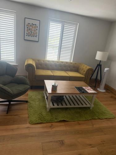 a living room with a couch and a coffee table at The Unicorn (Apartments) in Stow on the Wold