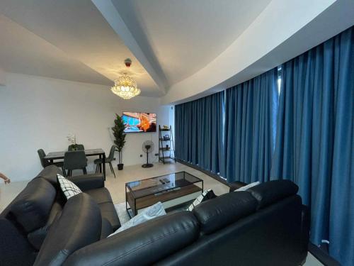 a living room with a leather couch and a table at Minimalist 1BR Condo with NETFLIX at AEON TOWERS near Abreeza Mall by Rico in Davao City