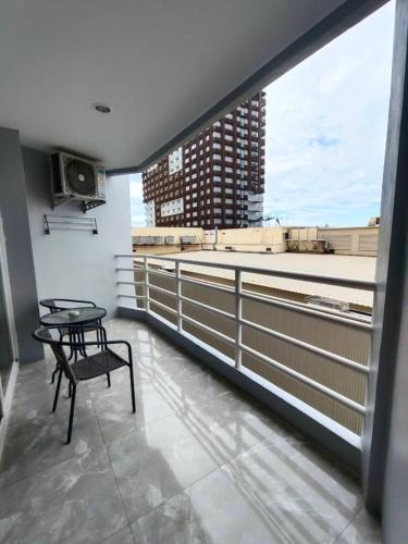 a balcony with a table and a view of a city at View Talay6 by Blue Ocean Suite in Pattaya Central
