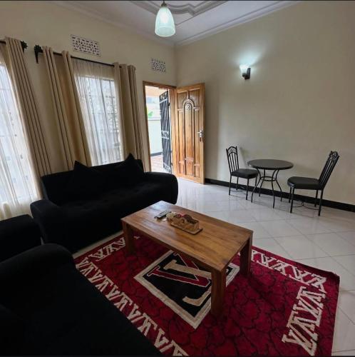 a living room with a couch and a coffee table at MD Apartments in Arusha