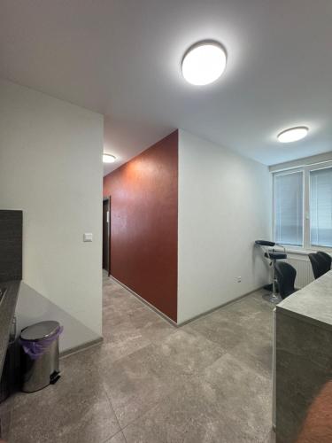 an office with a hallway with chairs and a wall at Ubytovanie Nitra in Nitra