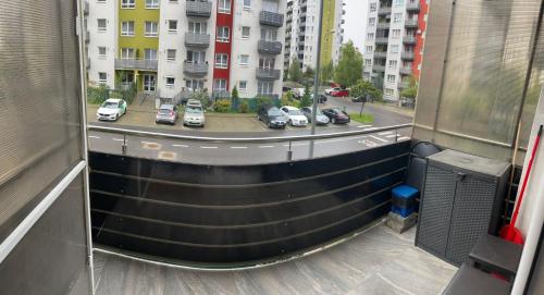 a balcony with cars parked in a parking lot at Avantgarden 3 Brasov by BuySellRent in Braşov