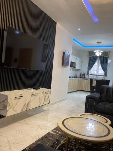a living room with a large flat screen tv on a wall at Rondawel Luxury 2 Bedroom Apartment, Lekki VGC in Lekki