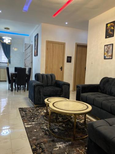 a living room with couches and a coffee table at Rondawel Luxury 2 Bedroom Apartment, Lekki VGC in Lekki
