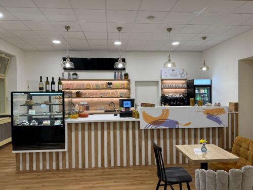 a restaurant with a counter with bottles of wine at Leháro in Litoměřice