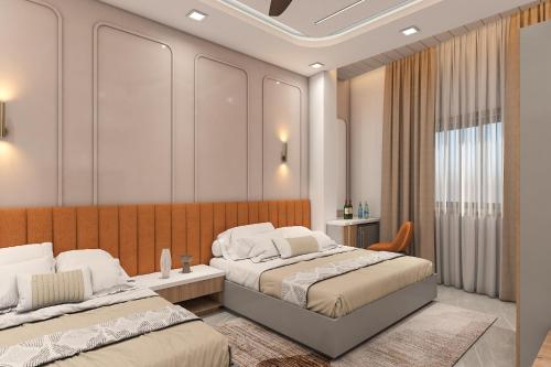 a bedroom with two beds and a window at Radiant Sky Hotel in Kuchāman City