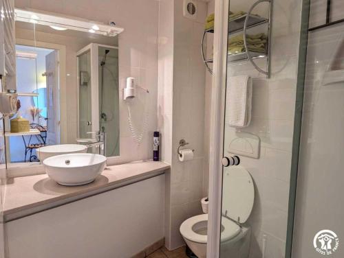 a bathroom with a sink and a toilet and a shower at La maison millesime in La Caunette