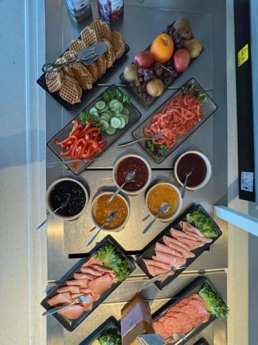 a display of different types of food on a table at Tjeldsundbrua Hotel in Evenskjer
