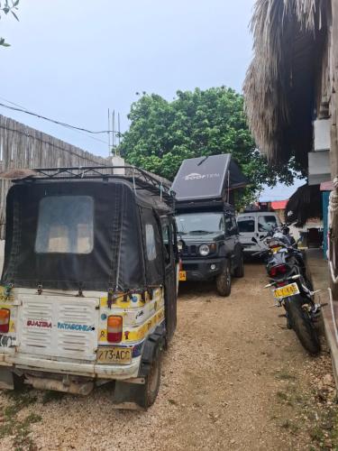 a group of vehicles parked next to a building at Sauka Loft Hostel in Rincón