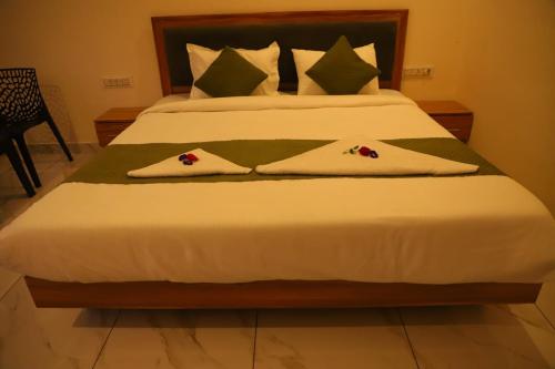 a bedroom with a bed with two towels on it at Be delight corbett in Rāmnagar