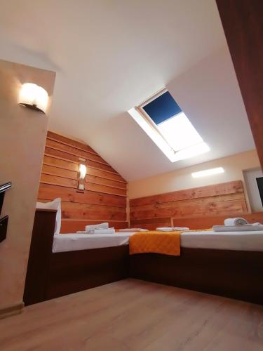 a room with two beds and a skylight at Boutique Guest House IKONOMOV in Bansko