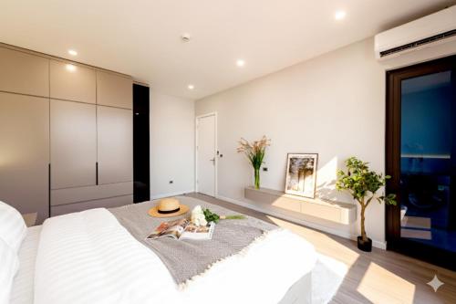 a bedroom with a large bed with a hat on it at Nagomi Apartment in Hanoi