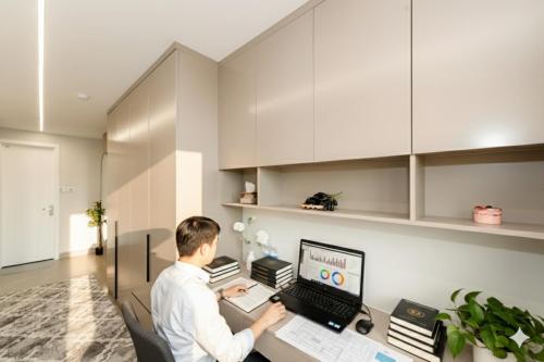 a man sitting at a desk with a computer at Nagomi Apartment in Hanoi