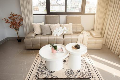 a living room with a couch and two tables at Nagomi Apartment in Hanoi