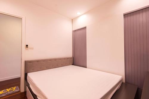 a small bedroom with a white bed in it at Paradise Apartment Quang Khanh in Hanoi