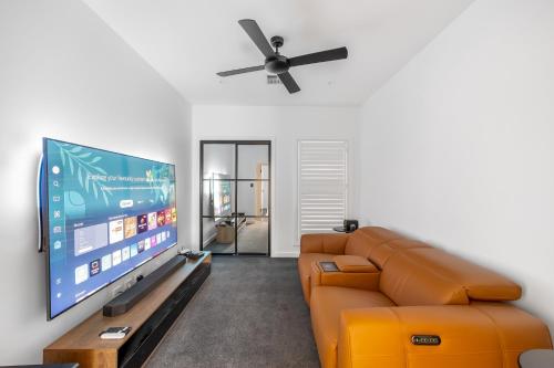 Una televisión o centro de entretenimiento en Jacaranda Amber The Vintage Golfside Luxe Villa