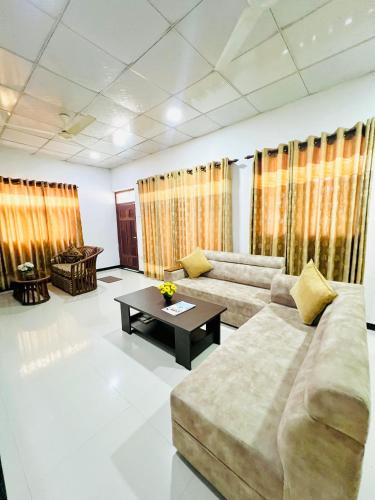 a living room with a couch and a coffee table at Marcelin Family Villa in Negombo