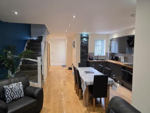 a kitchen and living room with a table and chairs at Balnakeil house