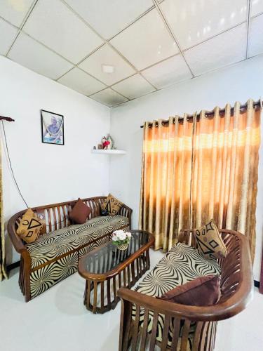 a living room with chairs and a couch at Marcelin Family Villa in Negombo