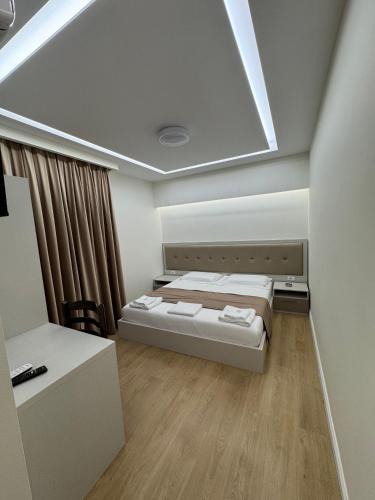 a bedroom with a bed and a skylight at 3D Hotel in Tirana