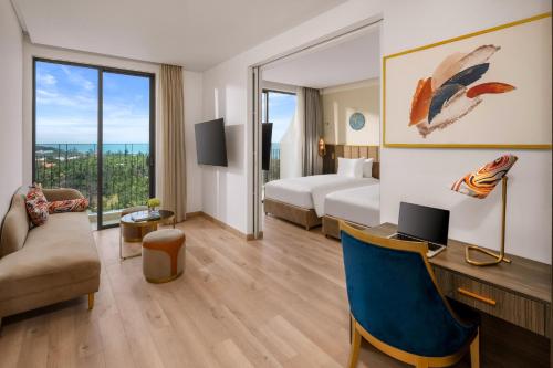 a hotel room with a bed and a desk at Wyndham Hoi An Royal Beachfront Resort & Villas in Hoi An