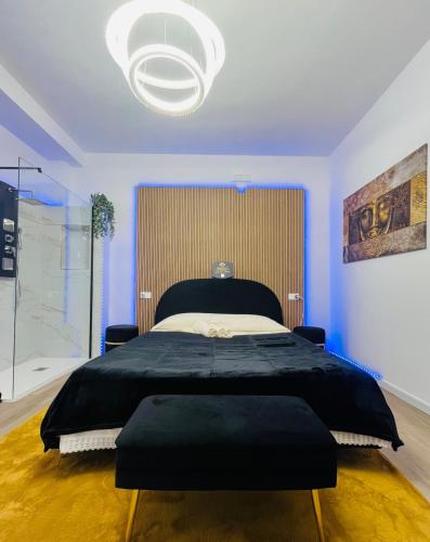 a bedroom with a large bed and a large chandelier at Your Exclusive Apulian Suite Near Matera in Ginosa