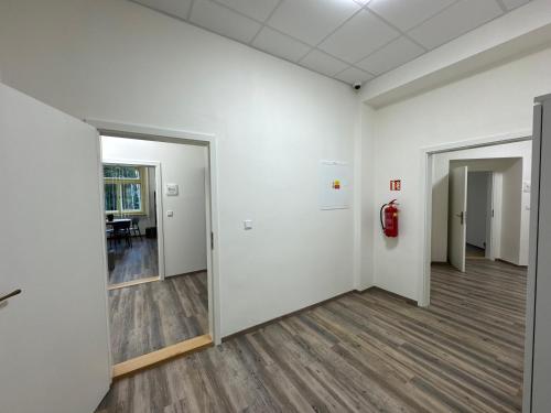 an empty room with white walls and a fire hydrant at Leháro in Litoměřice
