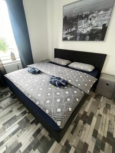 a bedroom with a bed with two clothes on it at City Apartment in Osnabrück