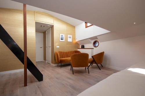 Un dormitorio con una cama y una mesa y sillas. en Luxury suite on houseboat, en Ámsterdam