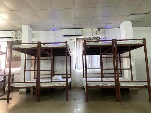 two bunk beds in a room with a mirror at JAI MATA DI DORMITORy in Muzaffarnagar