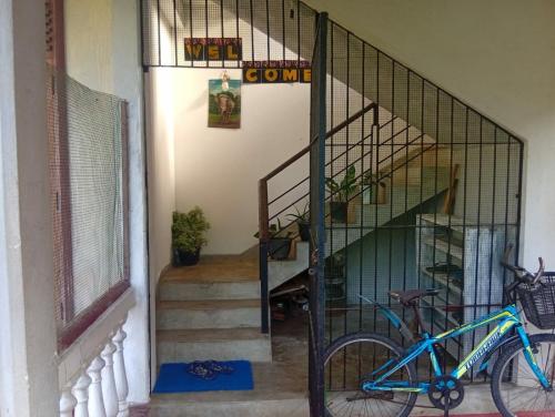 a bike parked next to a staircase in a house at Green House No 02 in Galle