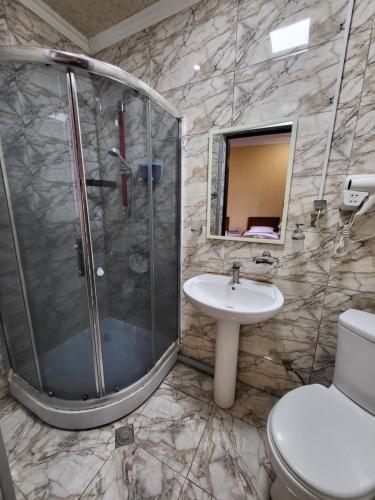 a bathroom with a shower and a toilet and a sink at GuestHouse Old Avlabari in Tbilisi City