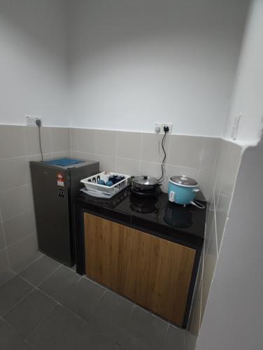 a small kitchen with a stove with pots and pans at CAMERON HIGHLAND CENRTUM BRINCHANG Homestay By Dcozy 6-7pax in Brinchang