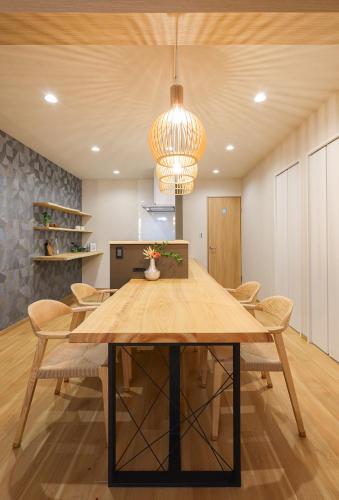 a dining room with a wooden table and chairs at ZenKyoto in Kyoto