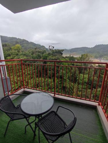 a table and two chairs on a balcony with a view at CAMERON HIGHLAND CENRTUM BRINCHANG Homestay By Dcozy 6-7pax in Brinchang