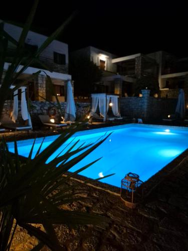 a large blue swimming pool at night at Malvazios Villas #4 in Gythio