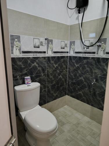 a bathroom with a toilet and a shower at Sunee'S Home Stay in Ahangama