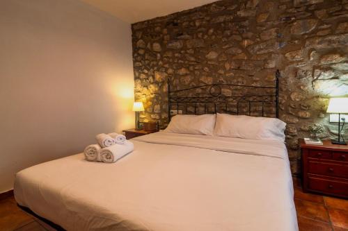 a bedroom with a large bed with towels on it at Sant Llorenç in Sant Llorenç de la Muga